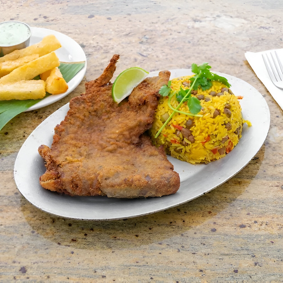 Amore Sabores' fried fish with yellow rice and a side of yucca fries and dipping sauce.