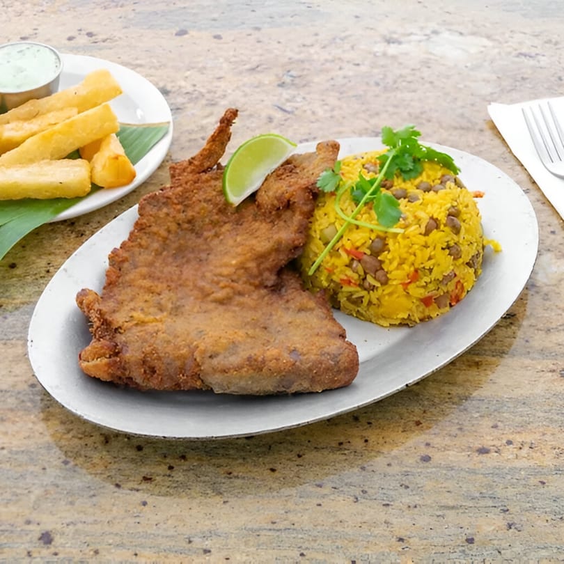 Amore Sabores' fried fish with yellow rice and a side of yucca fries and dipping sauce.